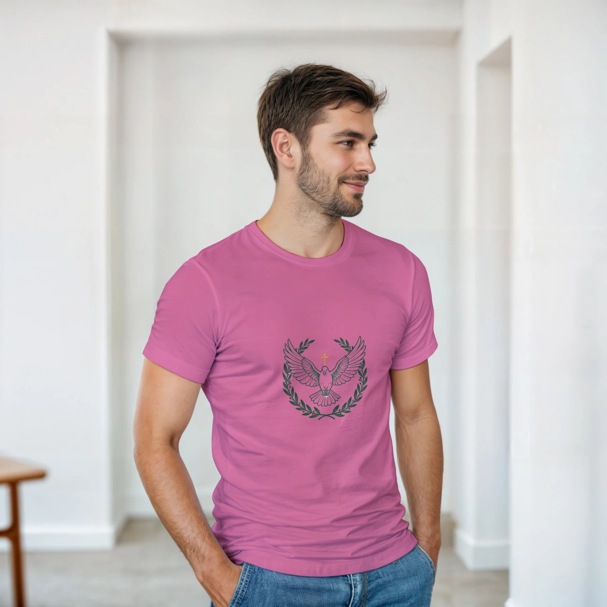 Pink t-shirt with a dove with wings spread inside an olive branch wreath below a cross