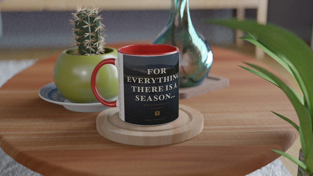 Ecclesiastes 3:1 Scripture Ceramic Mug with a red interior and handle, lifestyle shot on a wooden side table with a cactus and glass vase