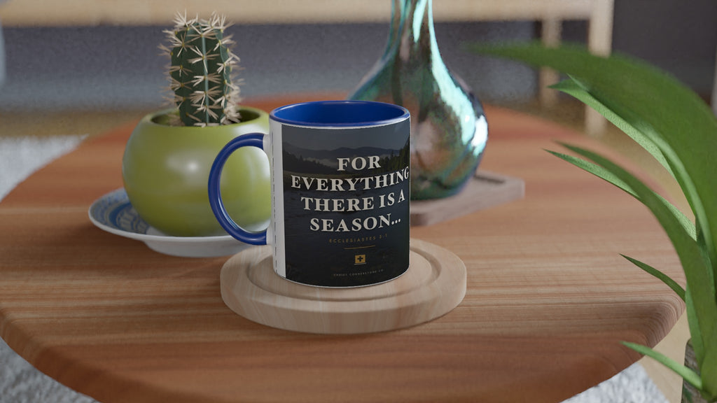Ecclesiastes 3:1 Scripture Ceramic Mug with a blue interior and handle, lifestyle shot on a wooden side table with a cactus and glass vase