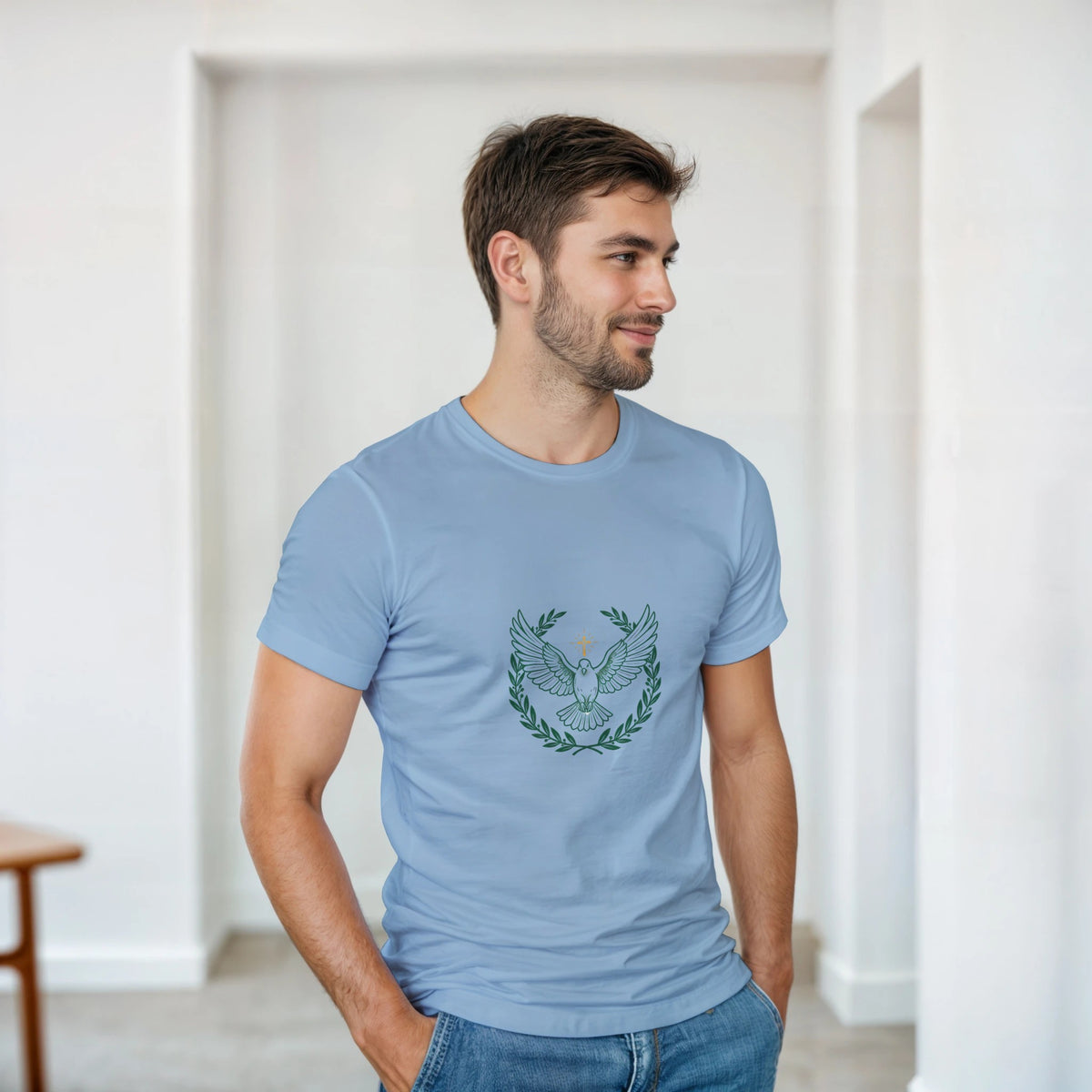 Light Blue t-shirt with a dove with wings spread inside an olive branch wreath below a cross