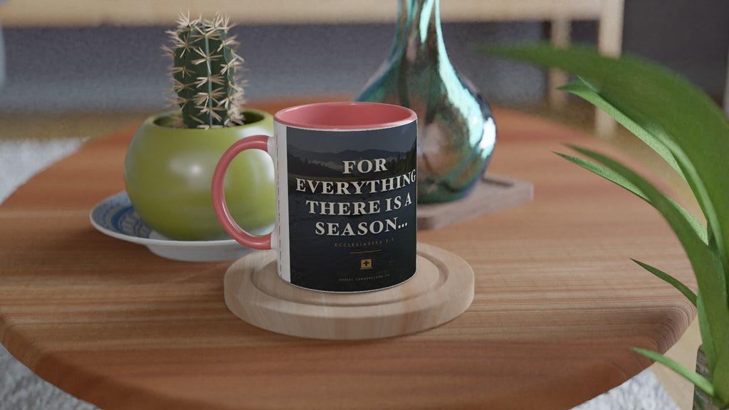 Ecclesiastes 3:1 Scripture Ceramic Mug with a pink interior and handle, lifestyle shot on a wooden side table with a cactus and glass vase