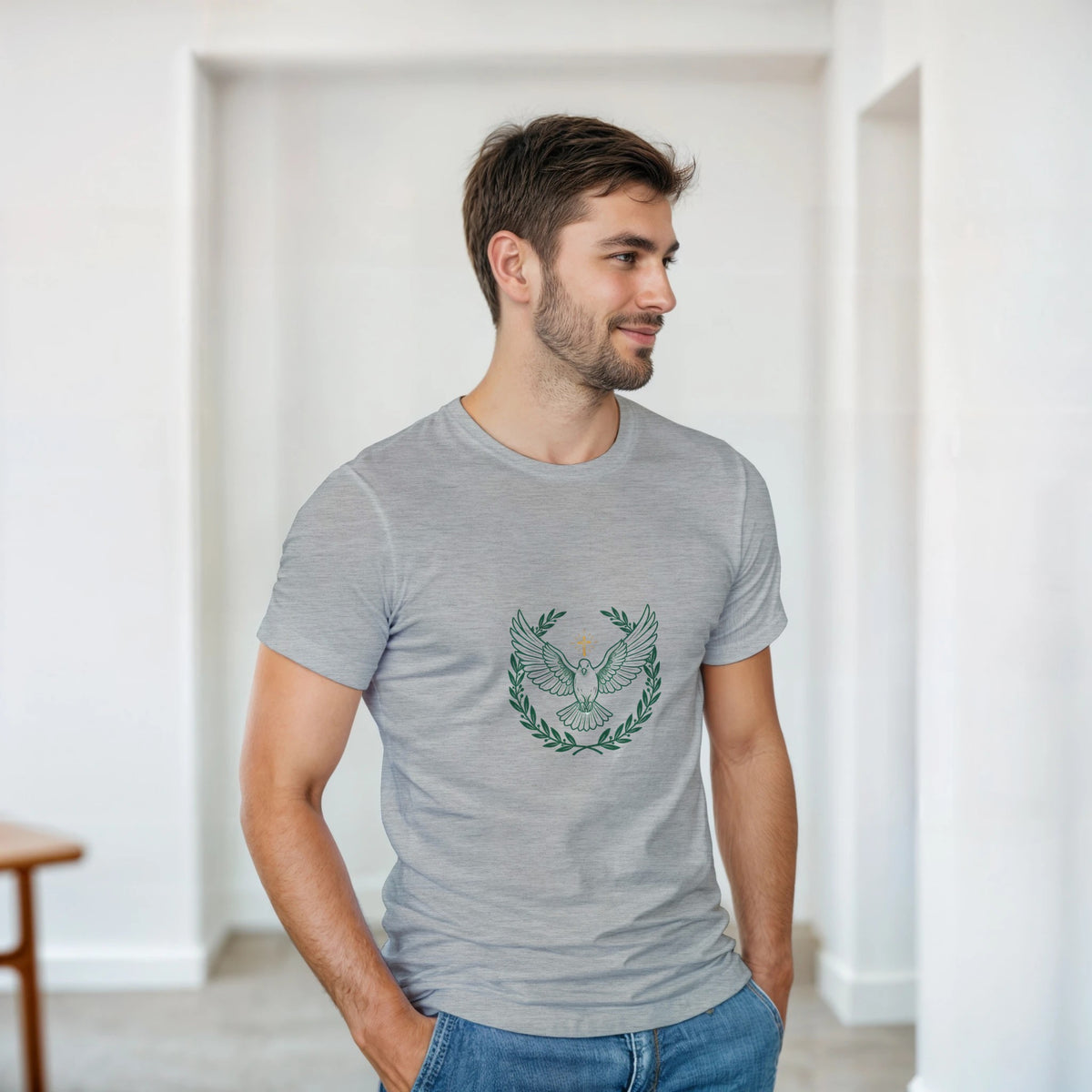Gray t-shirt with a dove with wings spread inside an olive branch wreath below a cross
