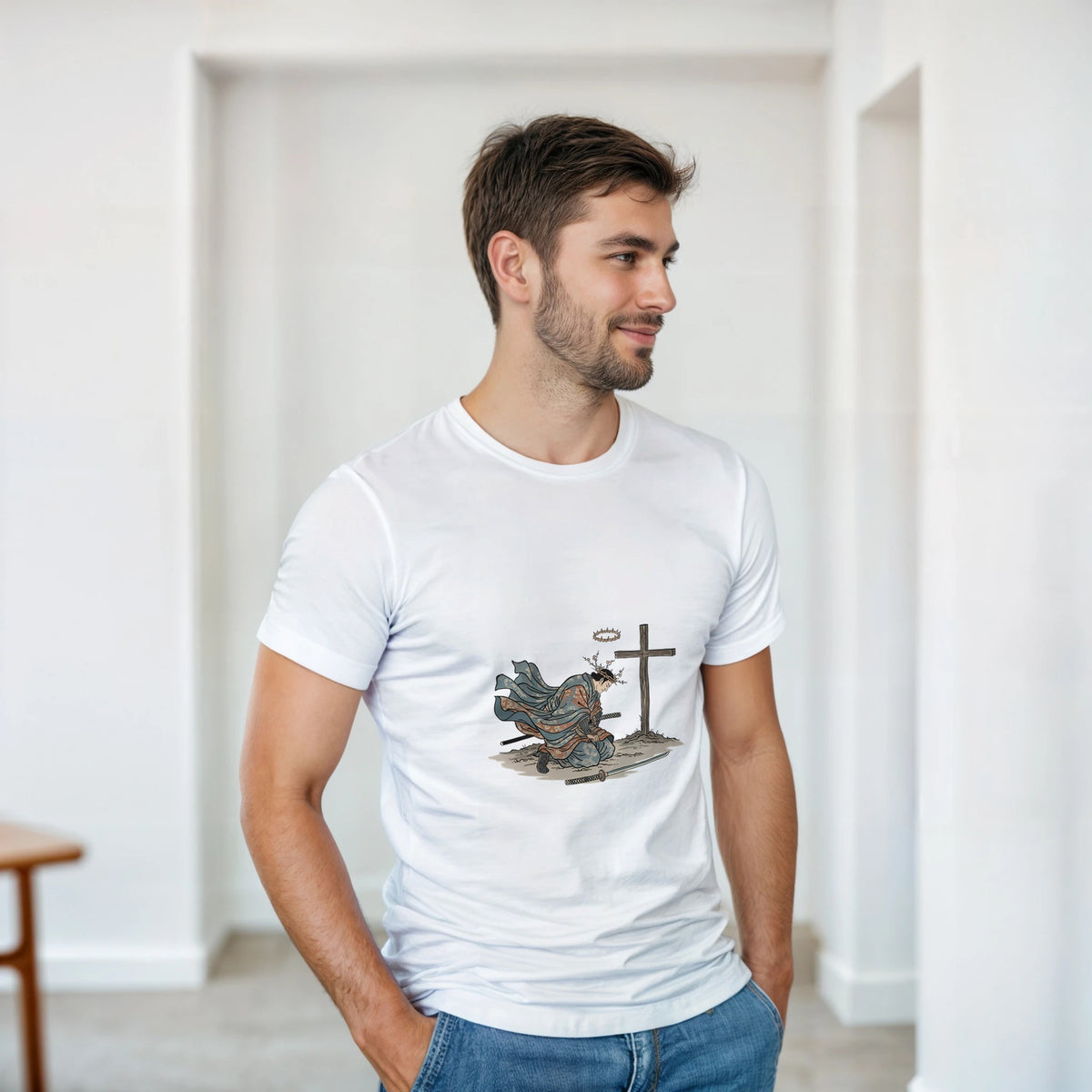 The Wind And The Cross Adult Tee in white, worn by a model indoors — an illustrated bird flying toward a wooden cross planted in rocky ground, with an Amen speech bubble
