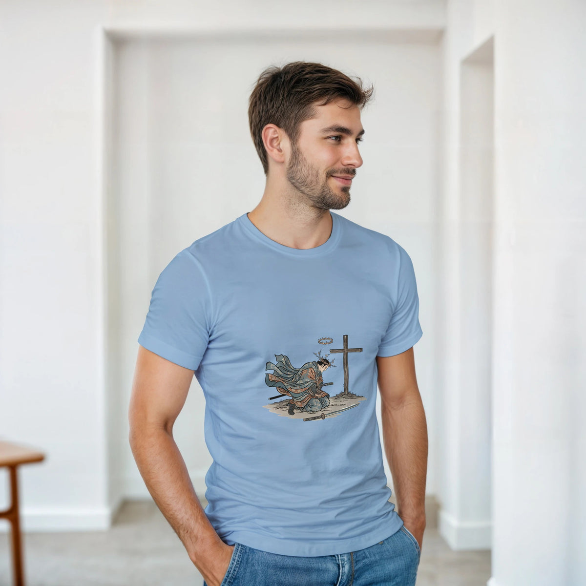 Light blue The Wind And The Cross Adult Tee, kneeling figure before a cross