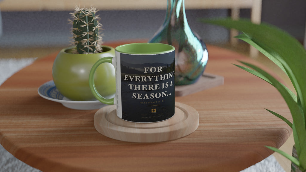 Ecclesiastes 3:1 Scripture Ceramic Mug with a green interior and handle, lifestyle shot on a wooden side table with a cactus and glass vase
