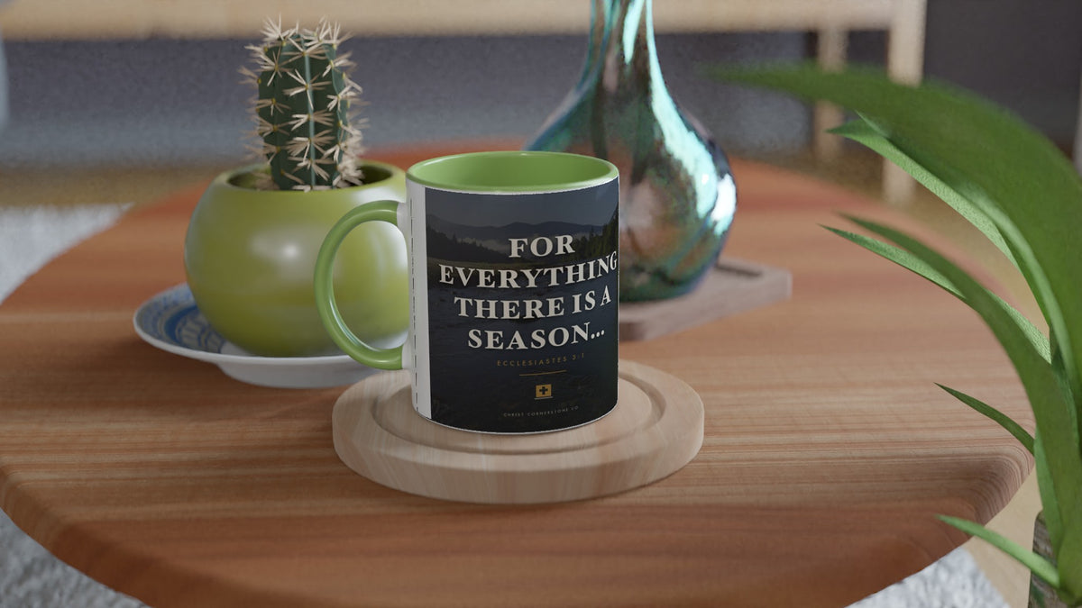 Ecclesiastes 3:1 Scripture Ceramic Mug with a green interior and handle, lifestyle shot on a wooden side table with a cactus and glass vase