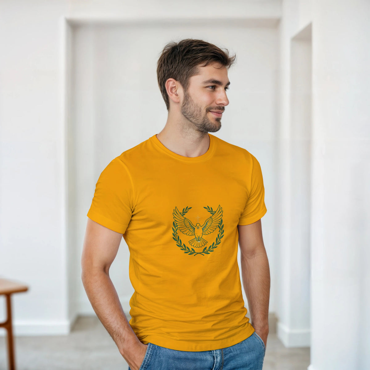 Gold t-shirt with a dove with wings spread inside an olive branch wreath below a cross
