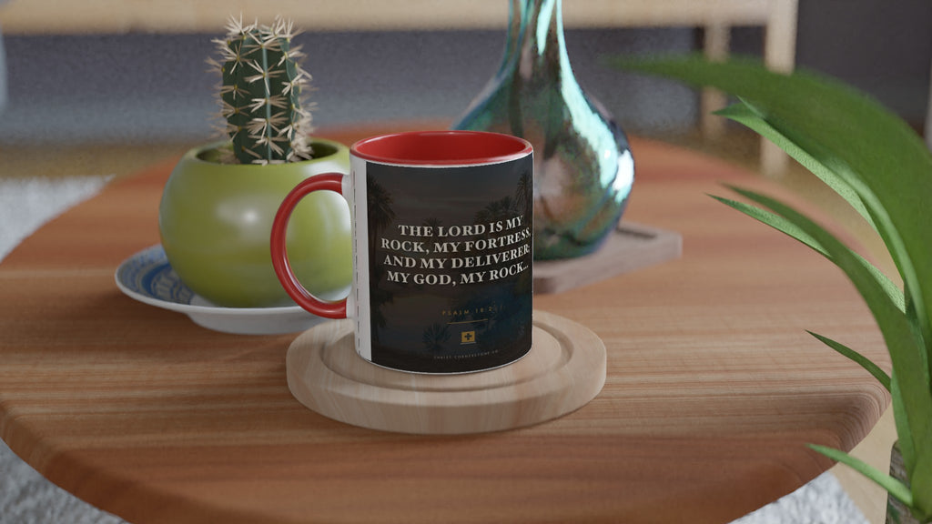 Psalm 18:2 ceramic mug with a blue interior and handle, on a side table with a cactus