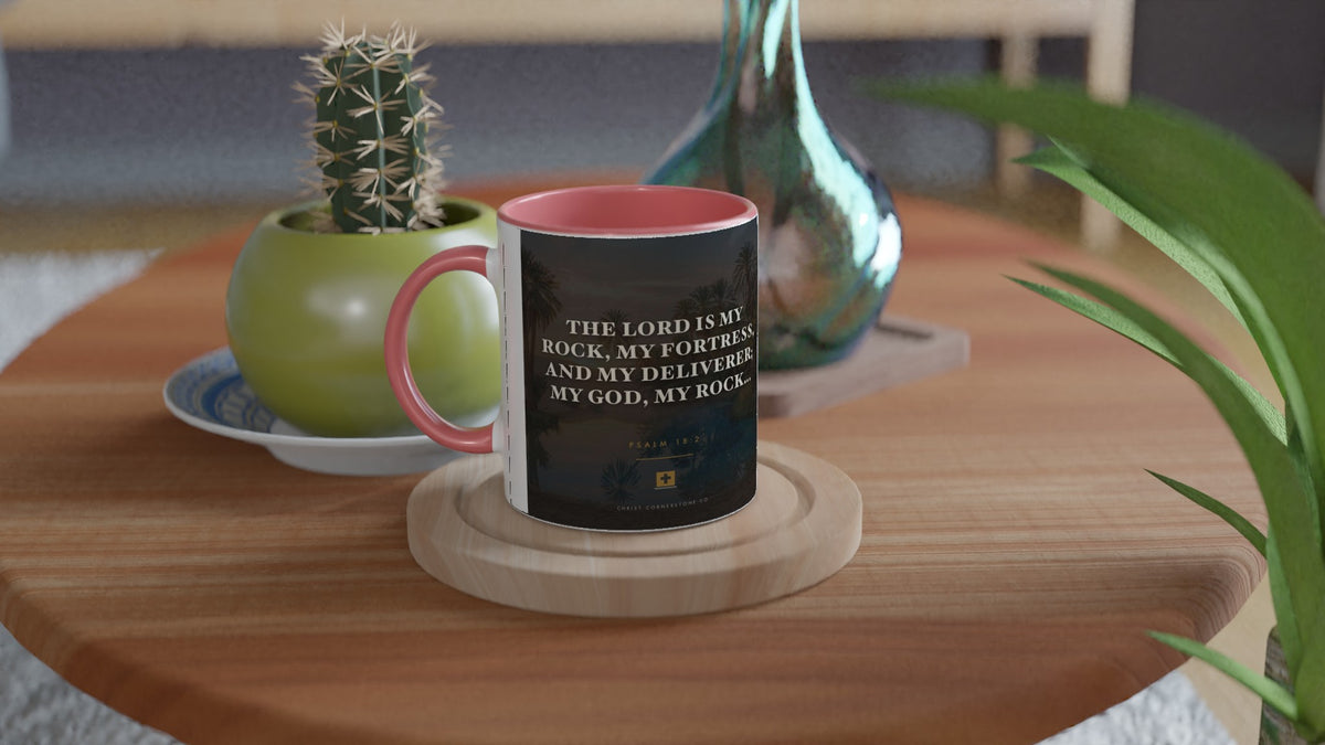 Psalm 18:2 ceramic mug with a pink interior and handle, on a side table with a cactus
