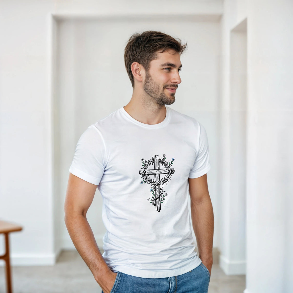 Crown Of Thorns Cross Adult Tee in white, worn by a model indoors — a black-and-white line-art cross entwined with a crown of thorns and small flowers